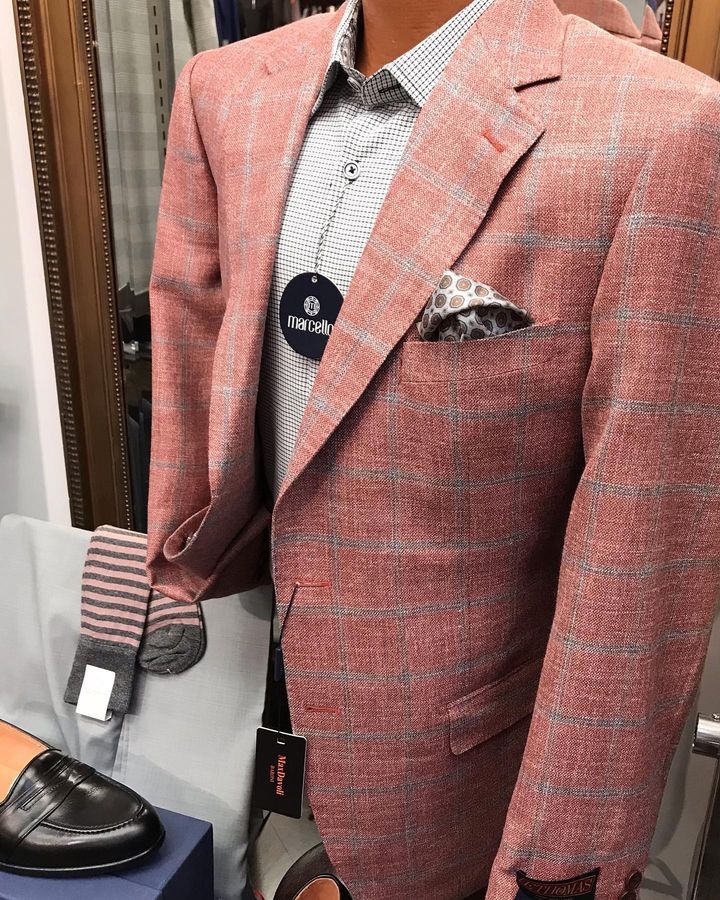 A mannequin is wearing a pink suit jacket