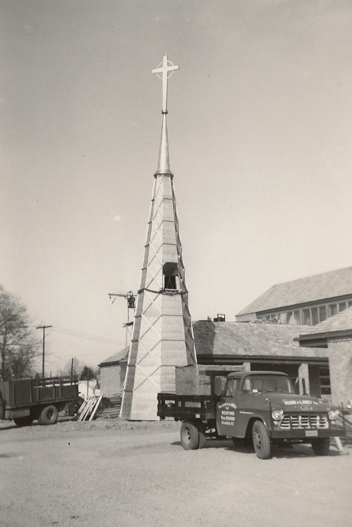 Construction of church steeple with a truck in the foreground.