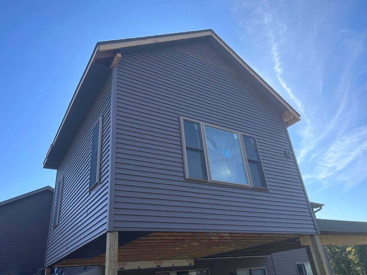 A house with a lot of windows and a blue sky in the background.