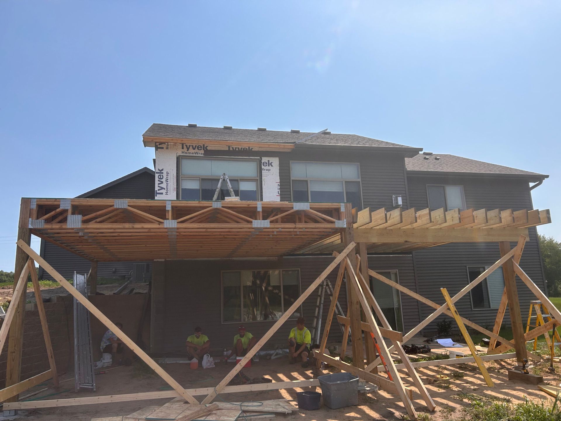A house is being built with a wooden deck.