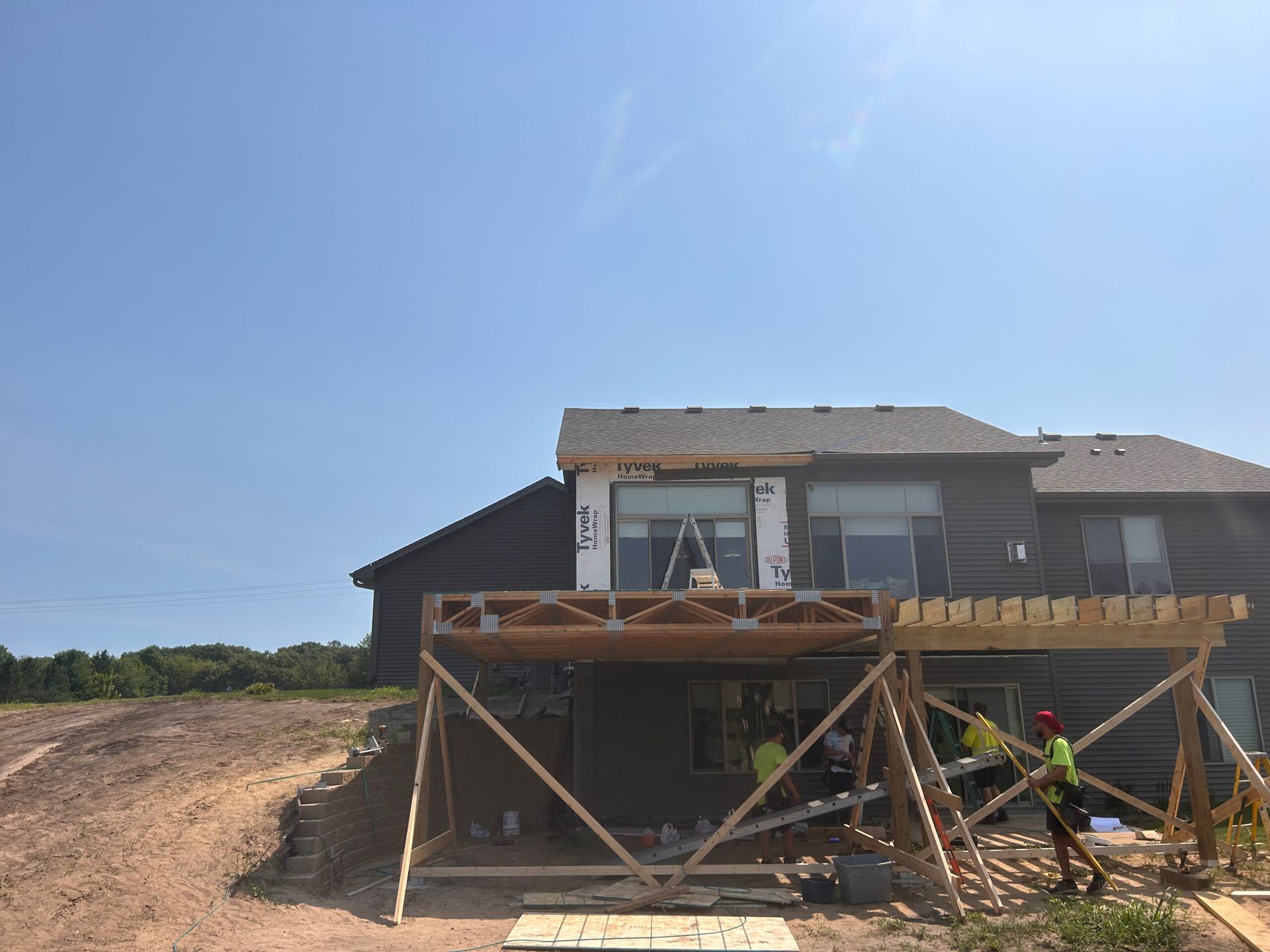 A house is being built with a wooden deck.