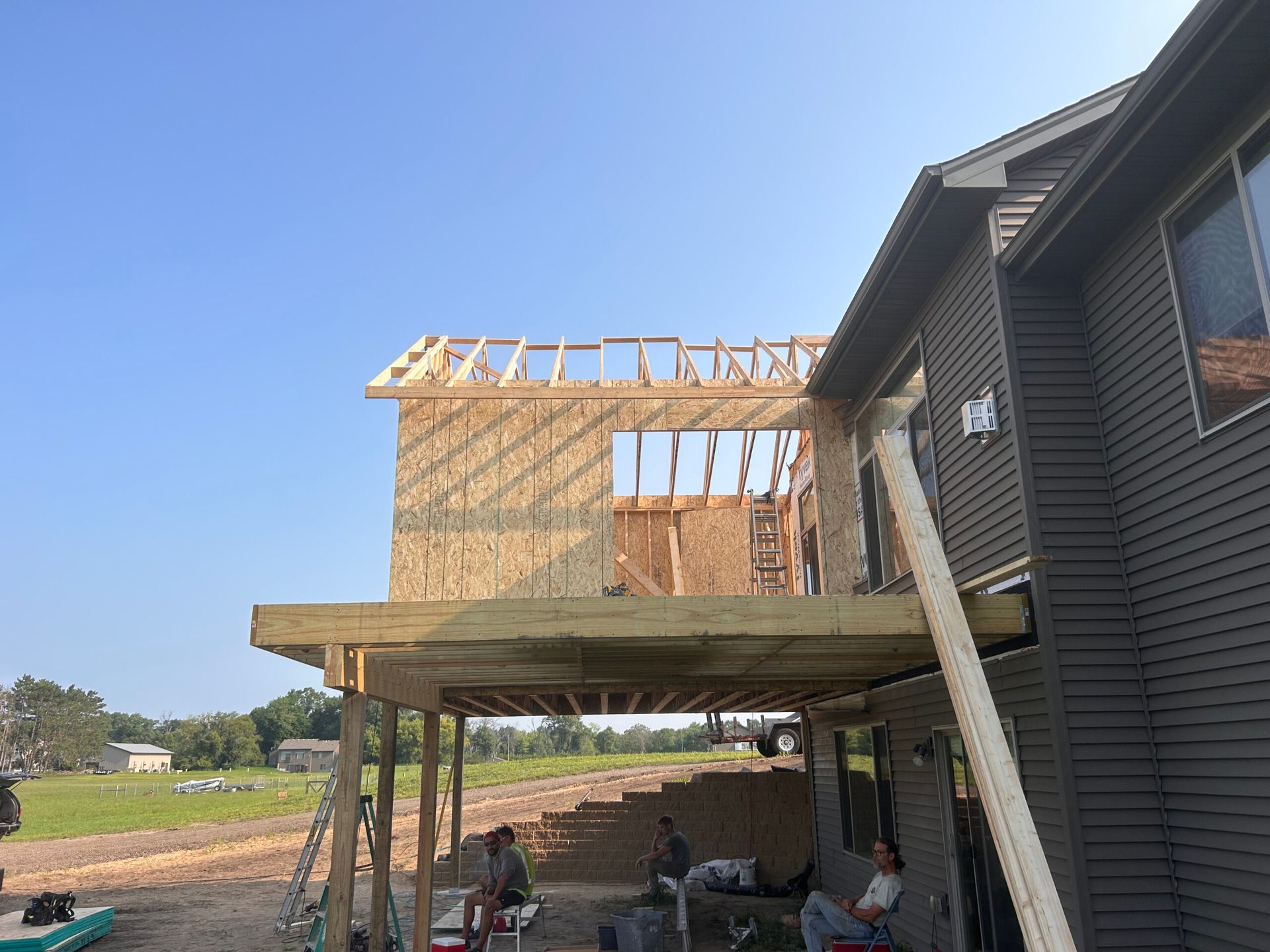 A house is being built with a deck and a roof.