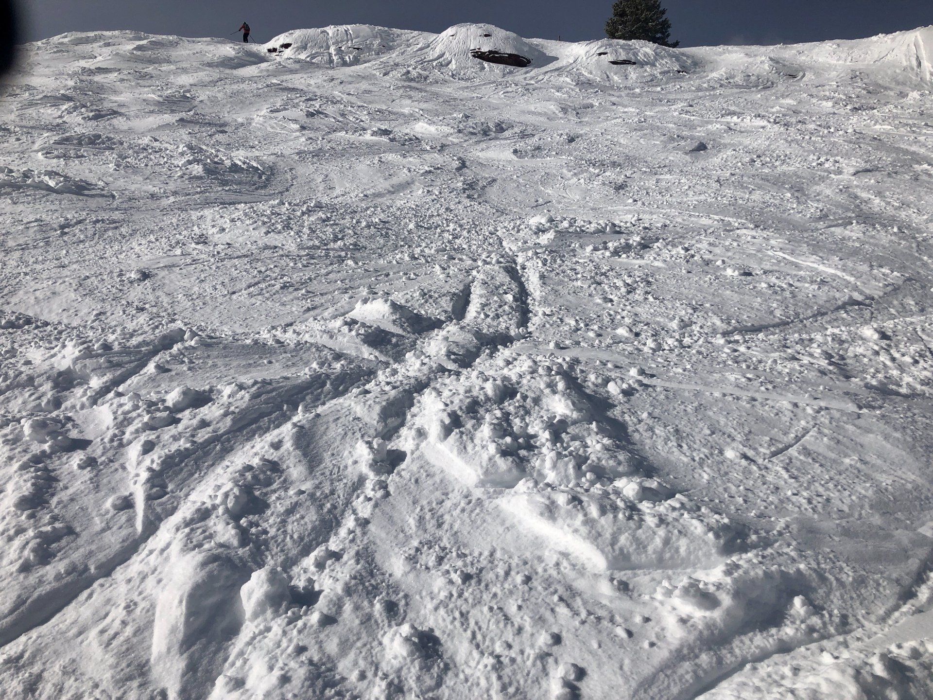 A person is skiing down a snow covered slope.