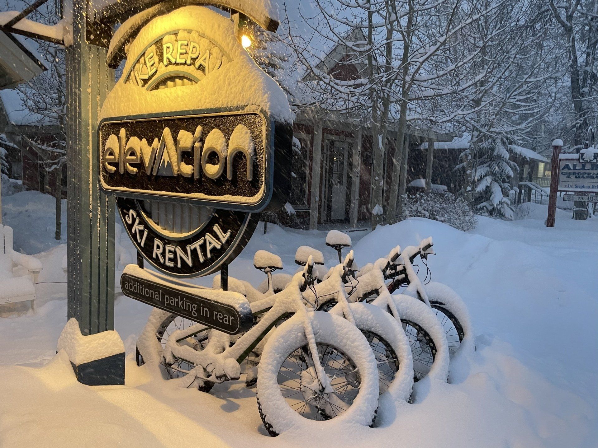 Elevation Ski & Bike sign and bikes covered in snow in Breckenridge, CO.