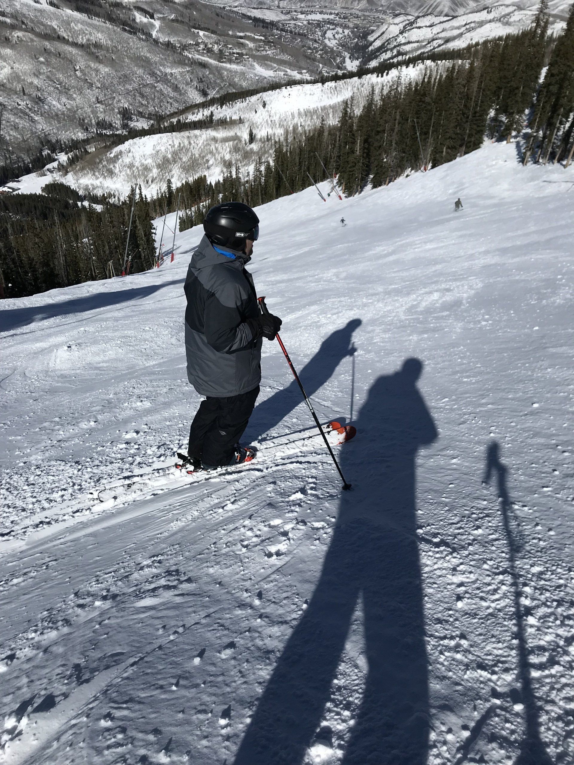 Skier standing on top of steep trail, Breckenridge, CO.