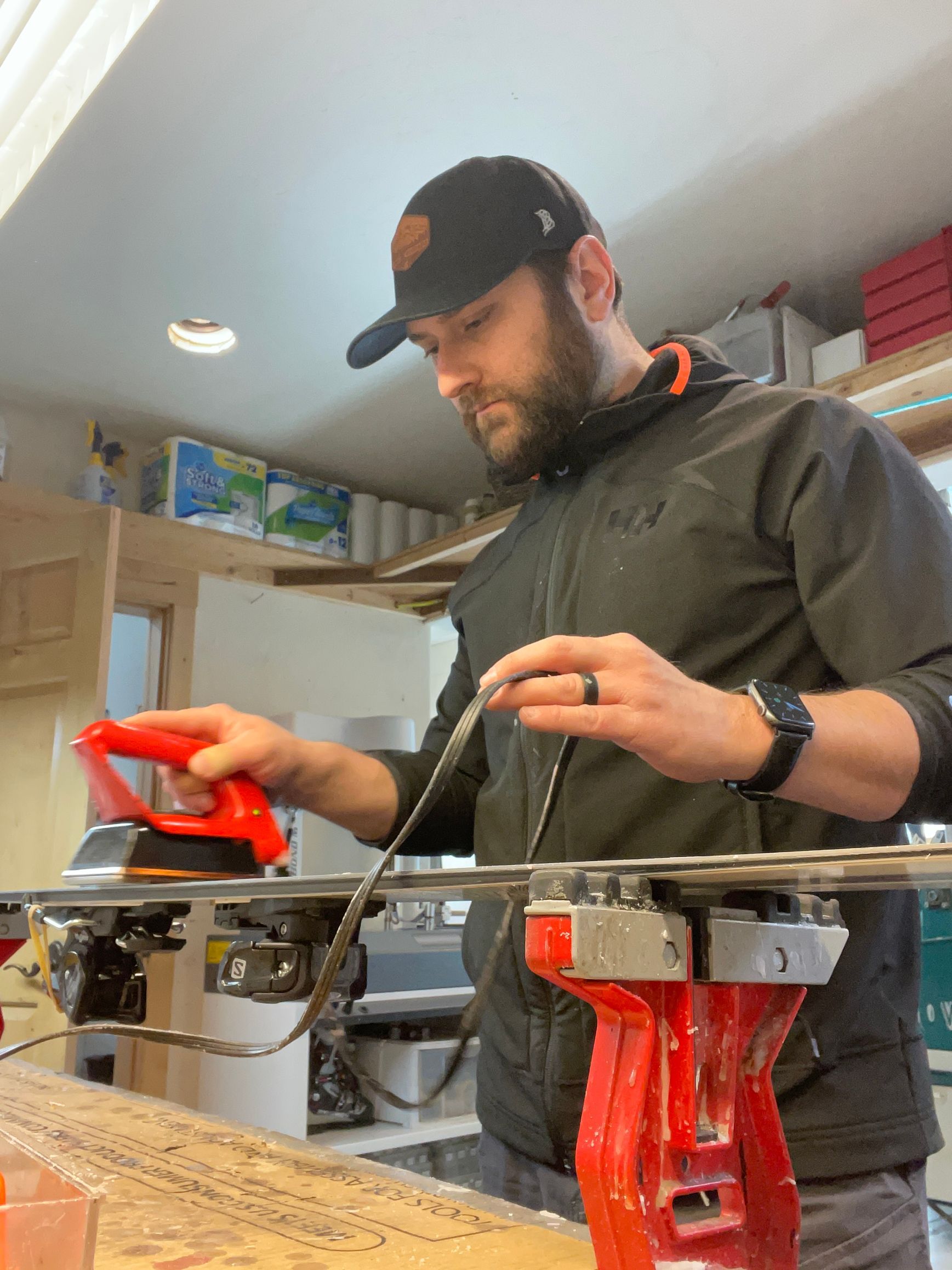 Elevation Ski & Bike employee waxing skis.