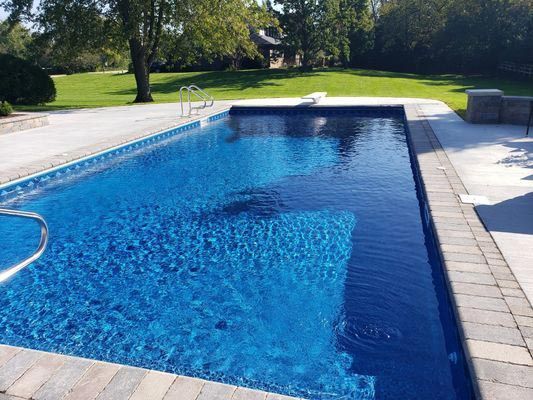 A large swimming pool with a staircase leading to it