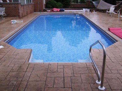 A large swimming pool with a staircase leading to it