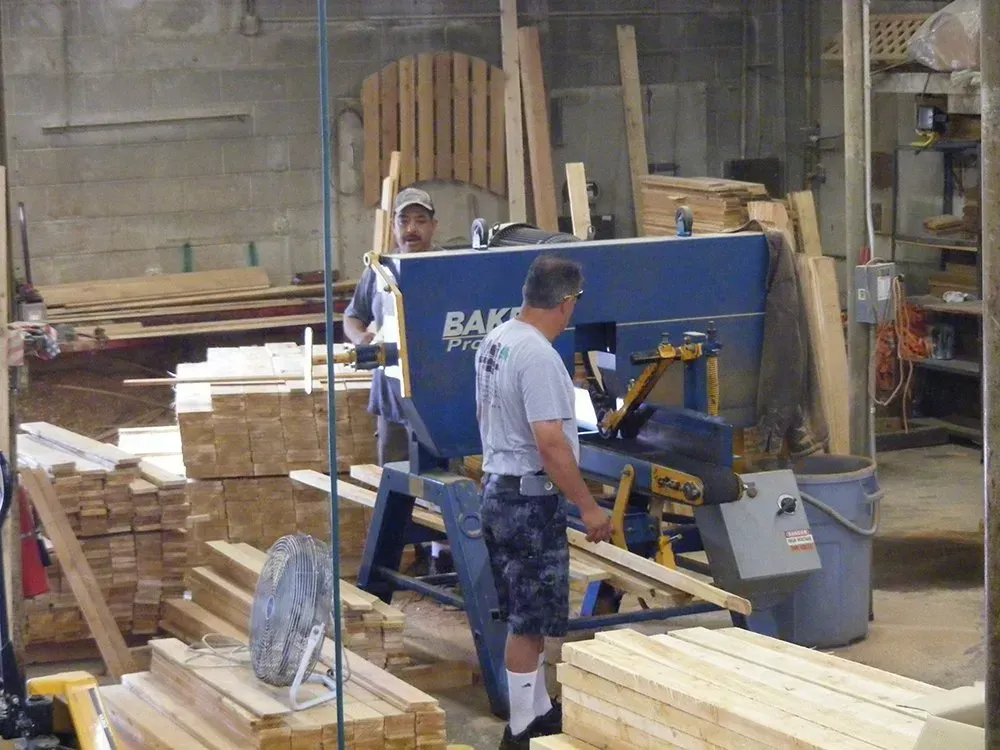A man is standing in front of a machine that says bak on it