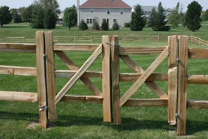 A wooden fence with a house in the background