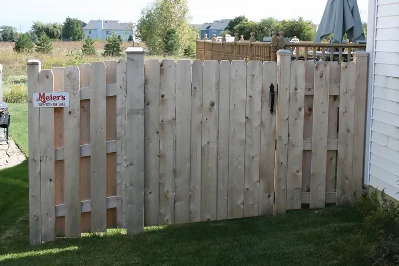 A wooden fence with a sign that says meyers on it