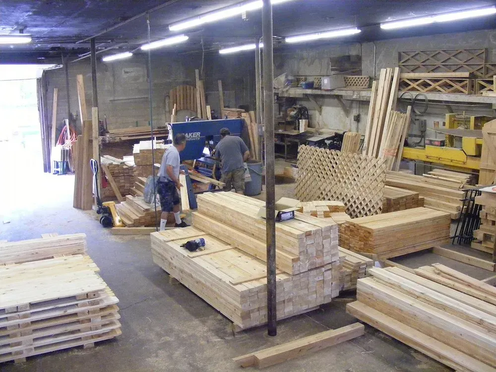 A warehouse filled with lots of wooden boards and pallets