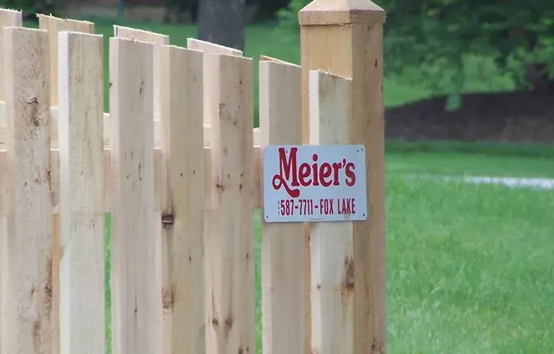 A wooden fence with a sign that says meier 's