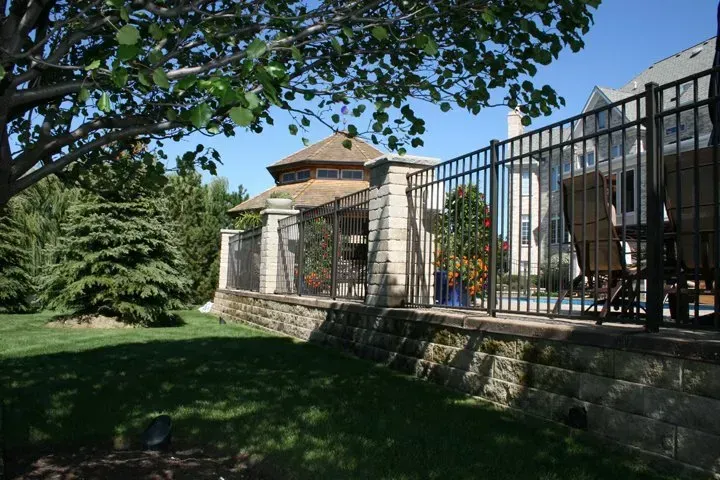 A large house with a fence around it and a pool