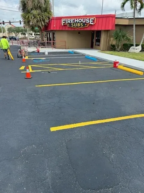 Firehouse Subs storefront with marked parking lot and cones blocking an accessible parking space