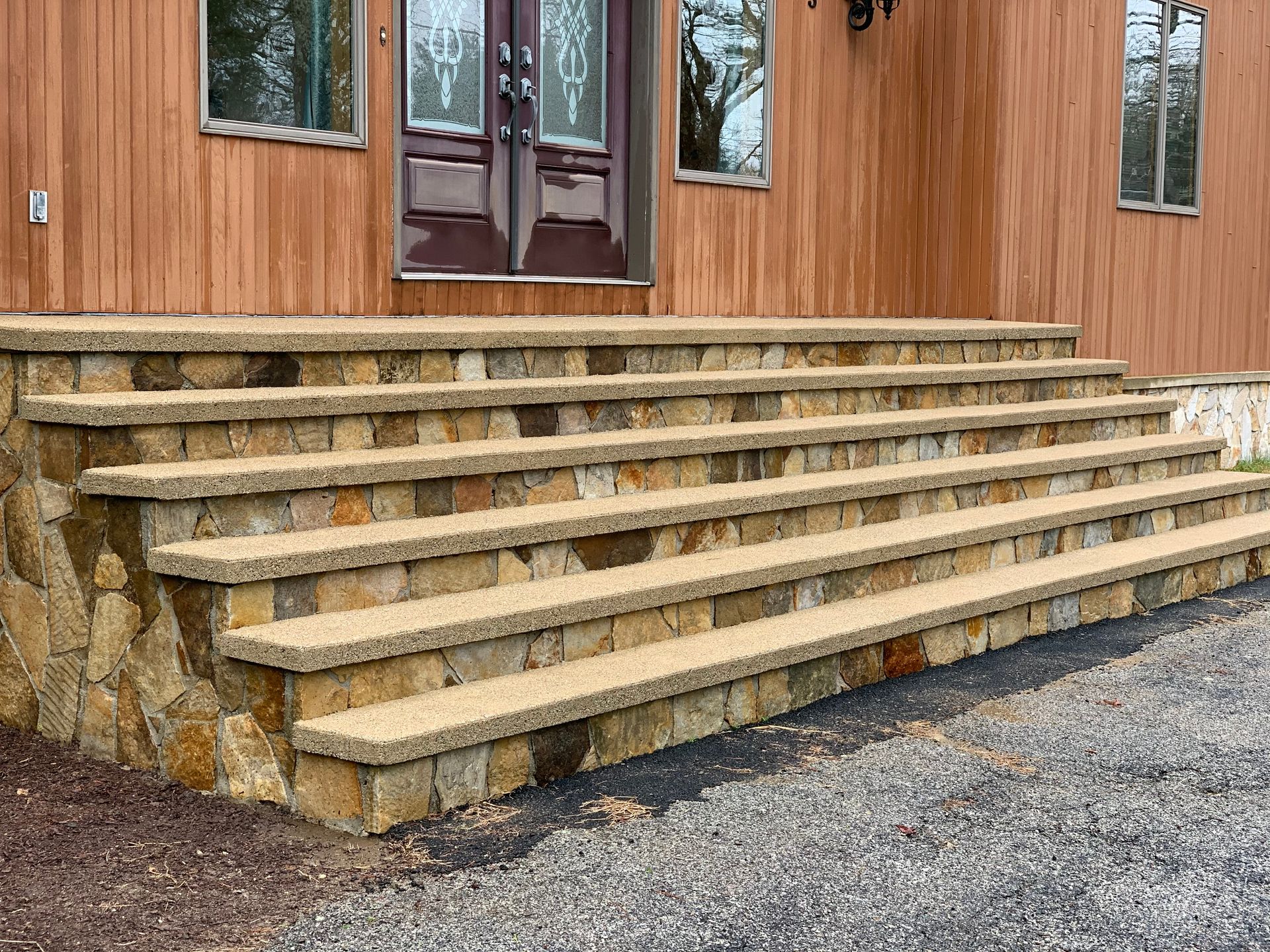A set of stone steps leading up to a wooden house