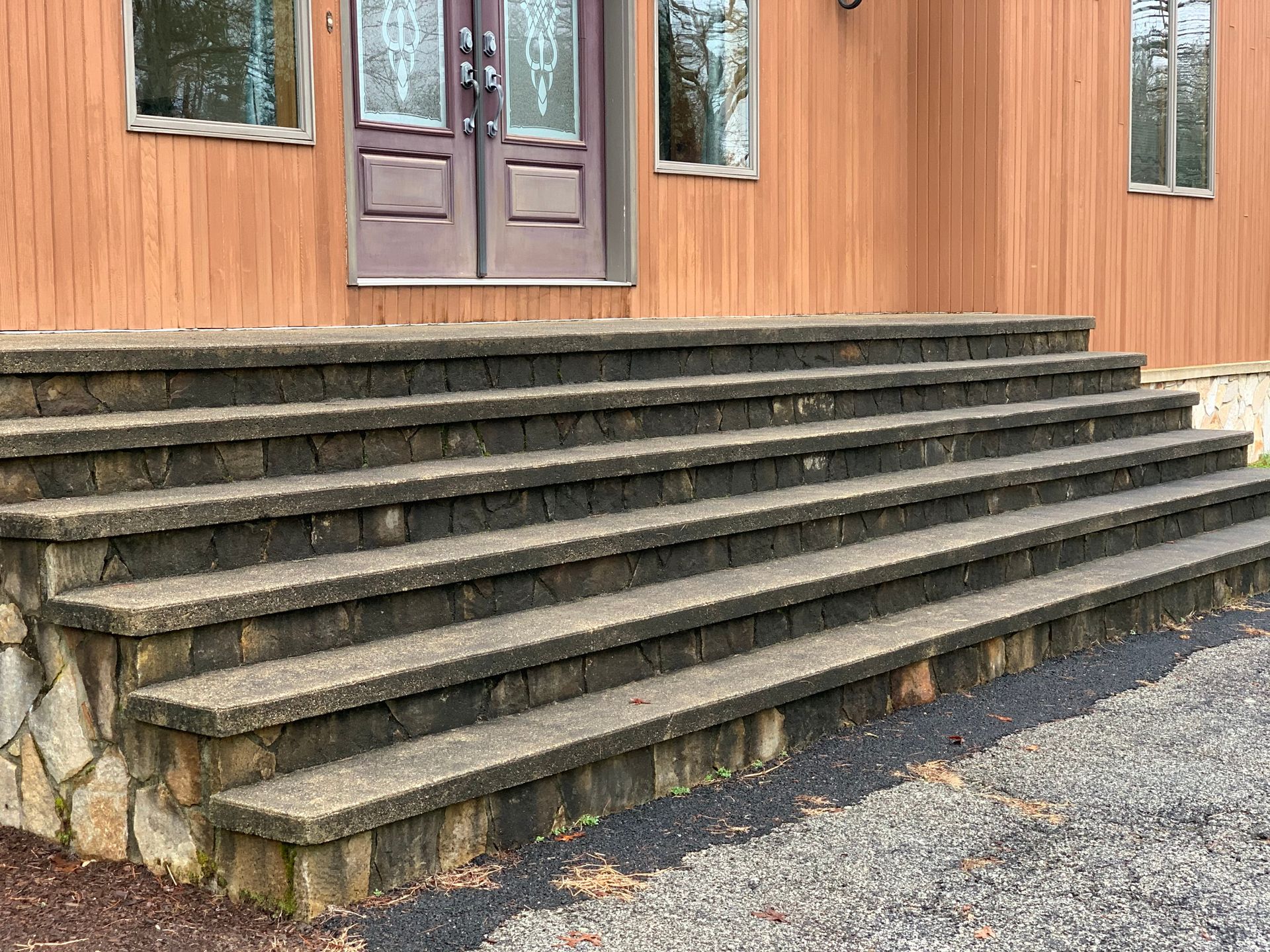 A set of stairs leading up to the front door of a house.