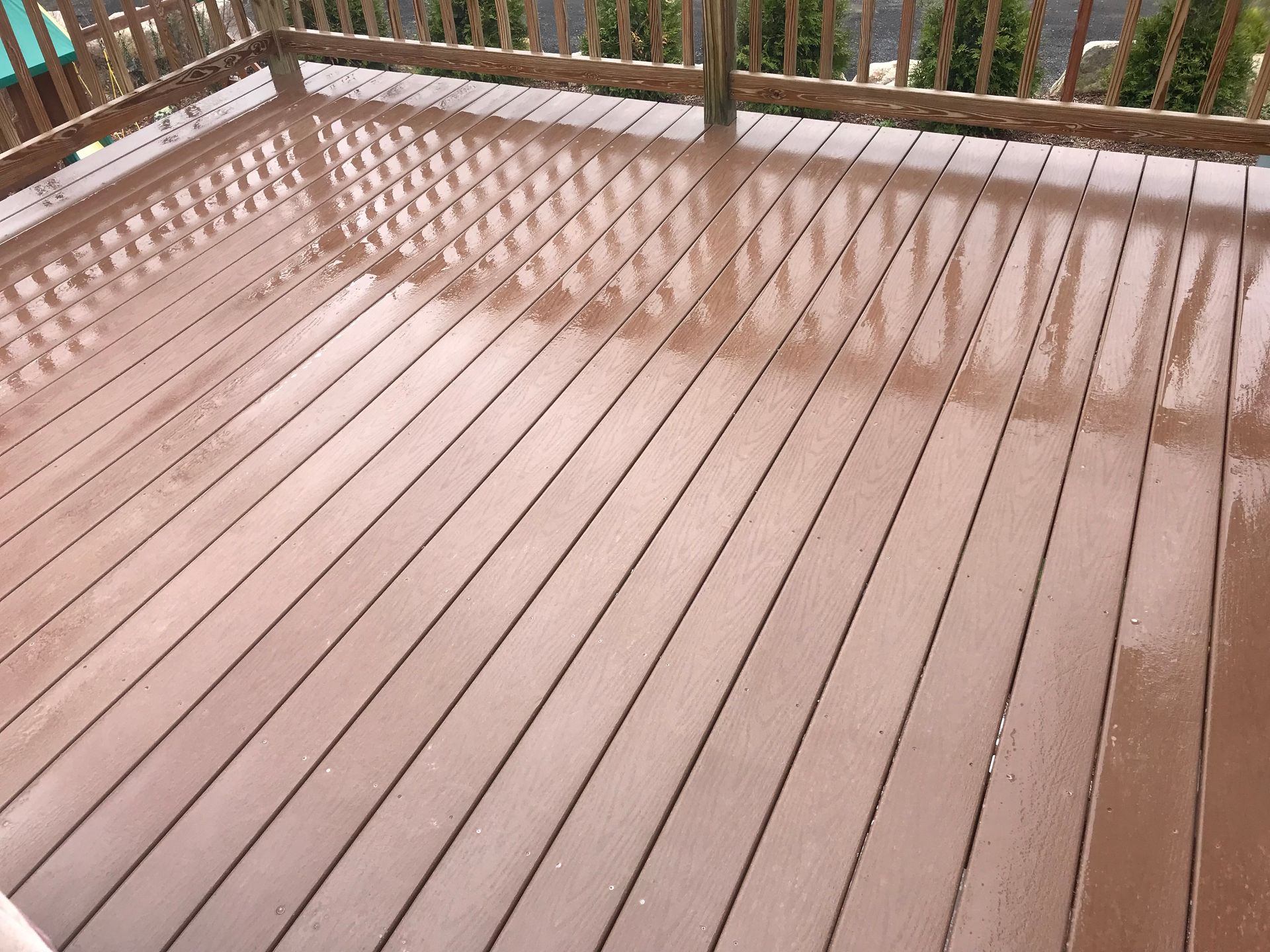 A close up of a wooden deck with a railing.
