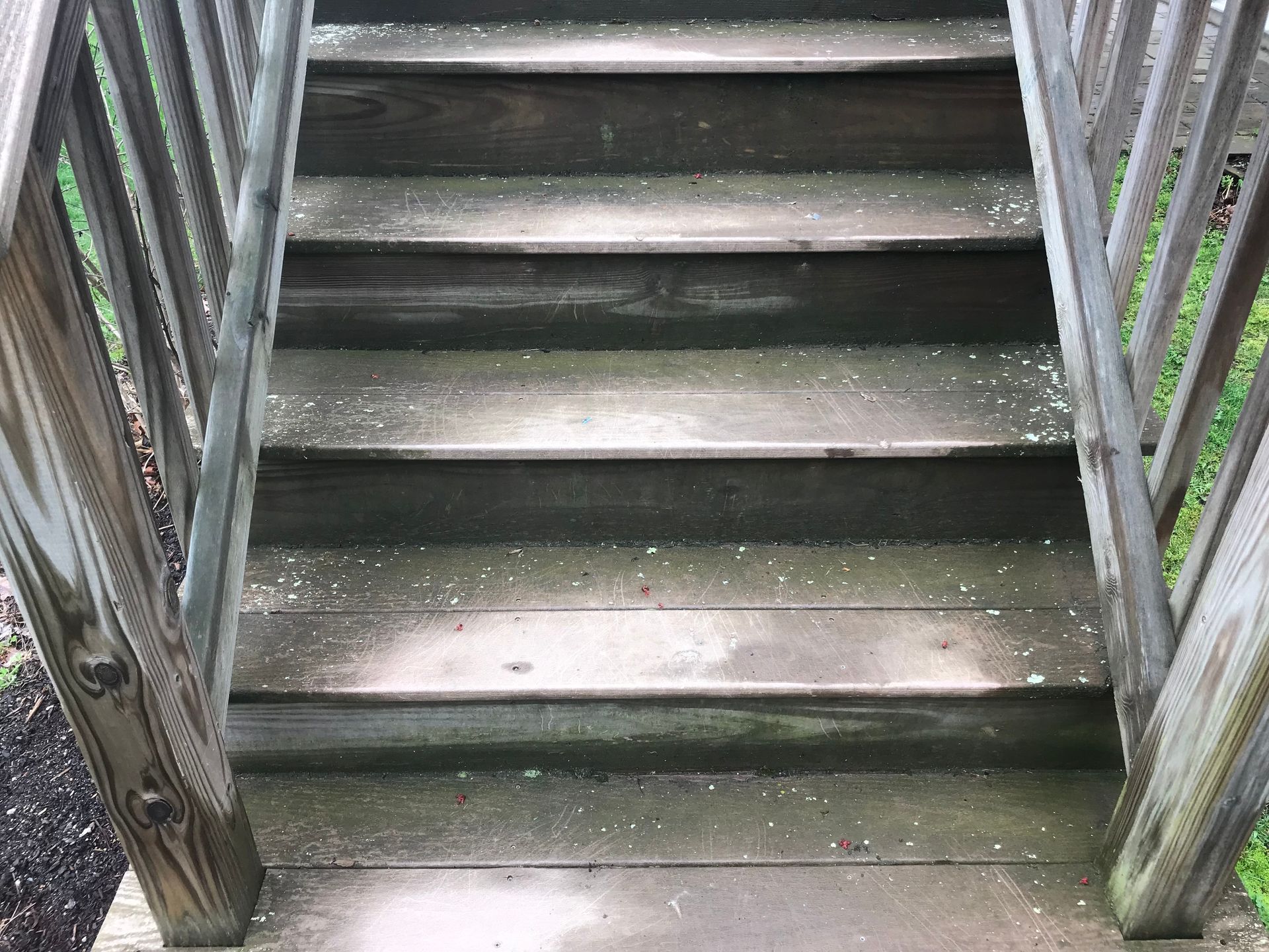 A close up of a wooden staircase with a railing.
