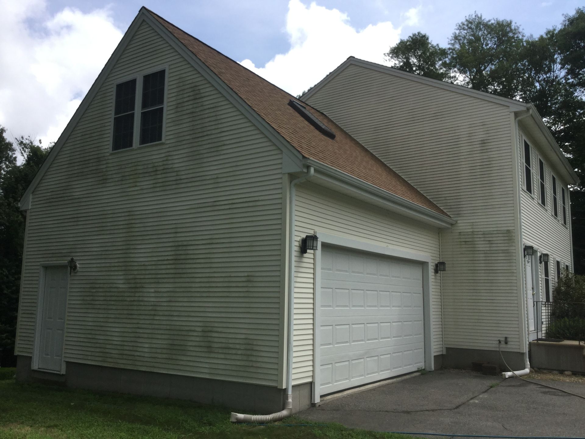 A white house with a garage and a roof