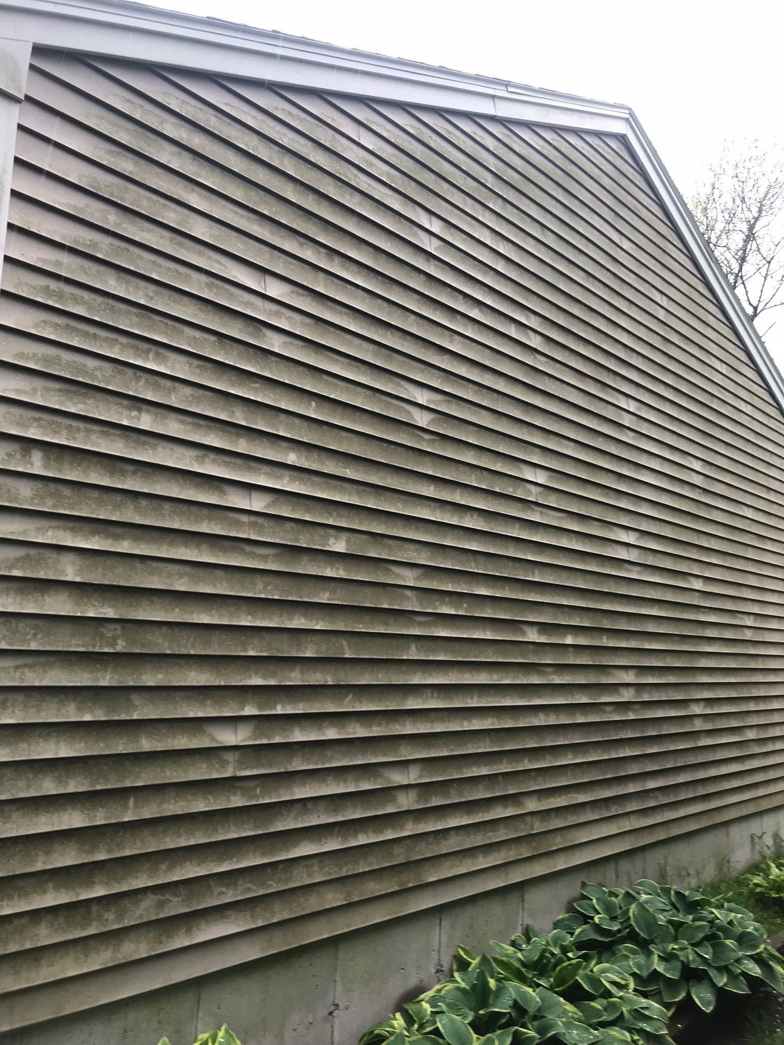 The side of a house with a lot of stains on it.