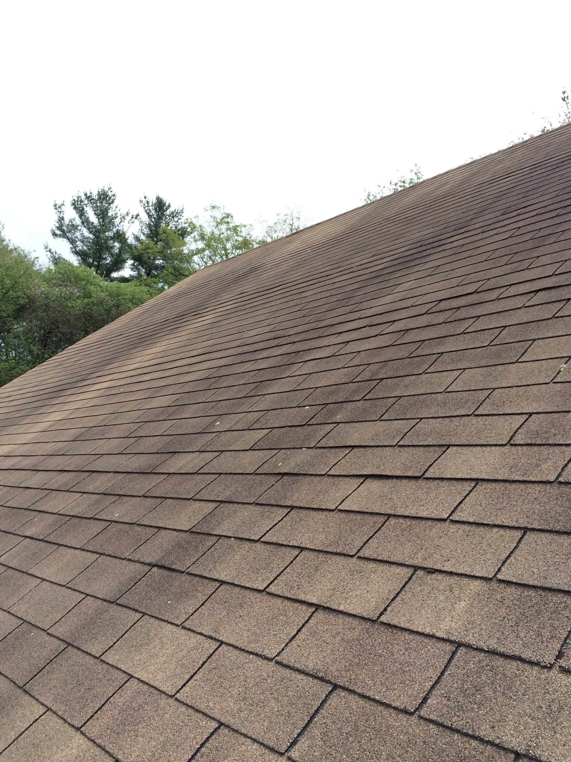A close up of a roof with a white sky in the background.