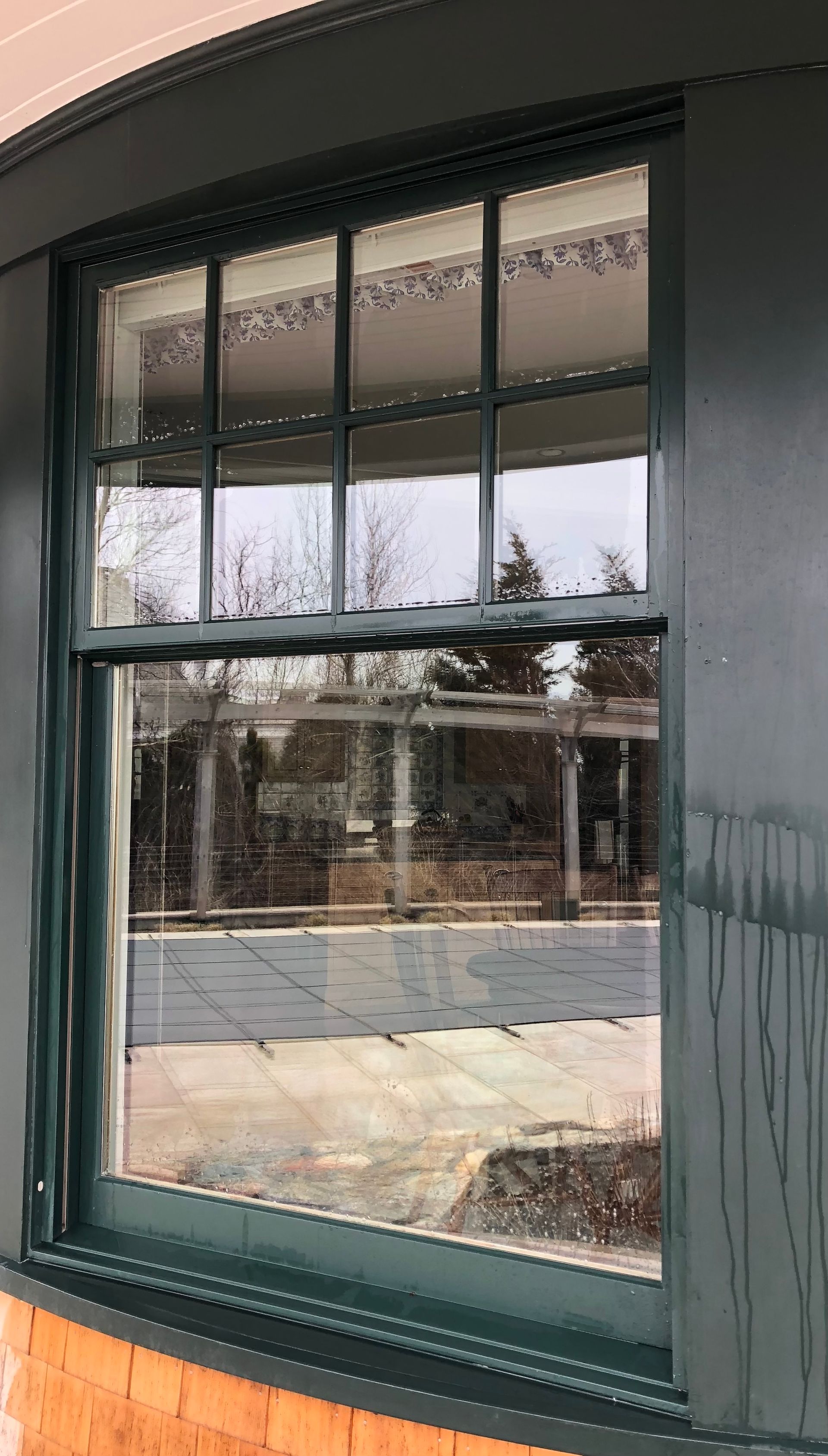 A close up of a window with a green frame on a building.