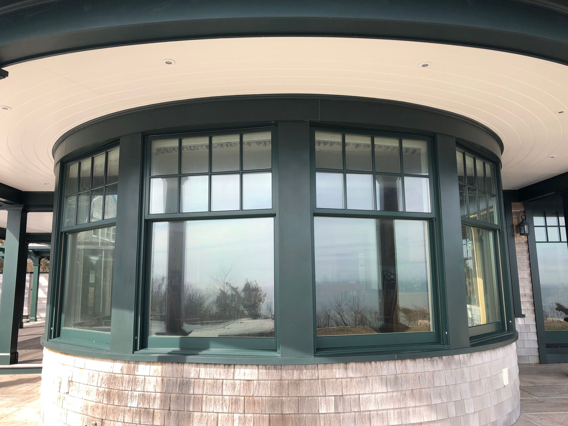 A round building with a lot of windows and a brick wall.