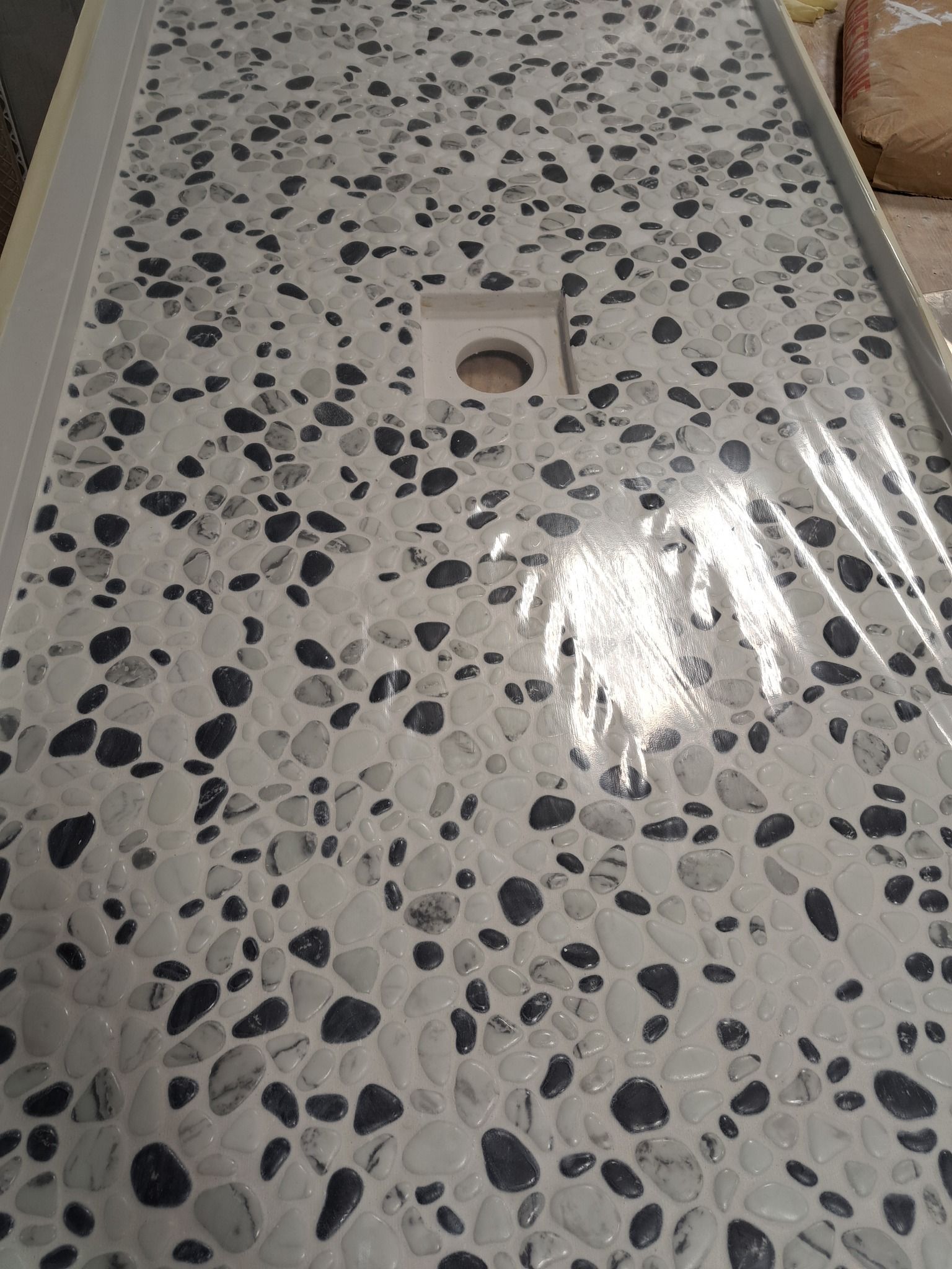 A close up of a counter top with black and white rocks on it.