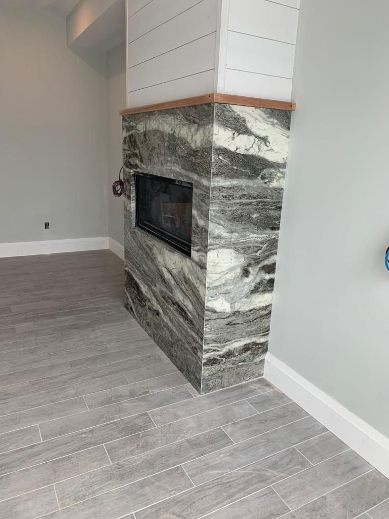 There is a fireplace in the corner of the room.