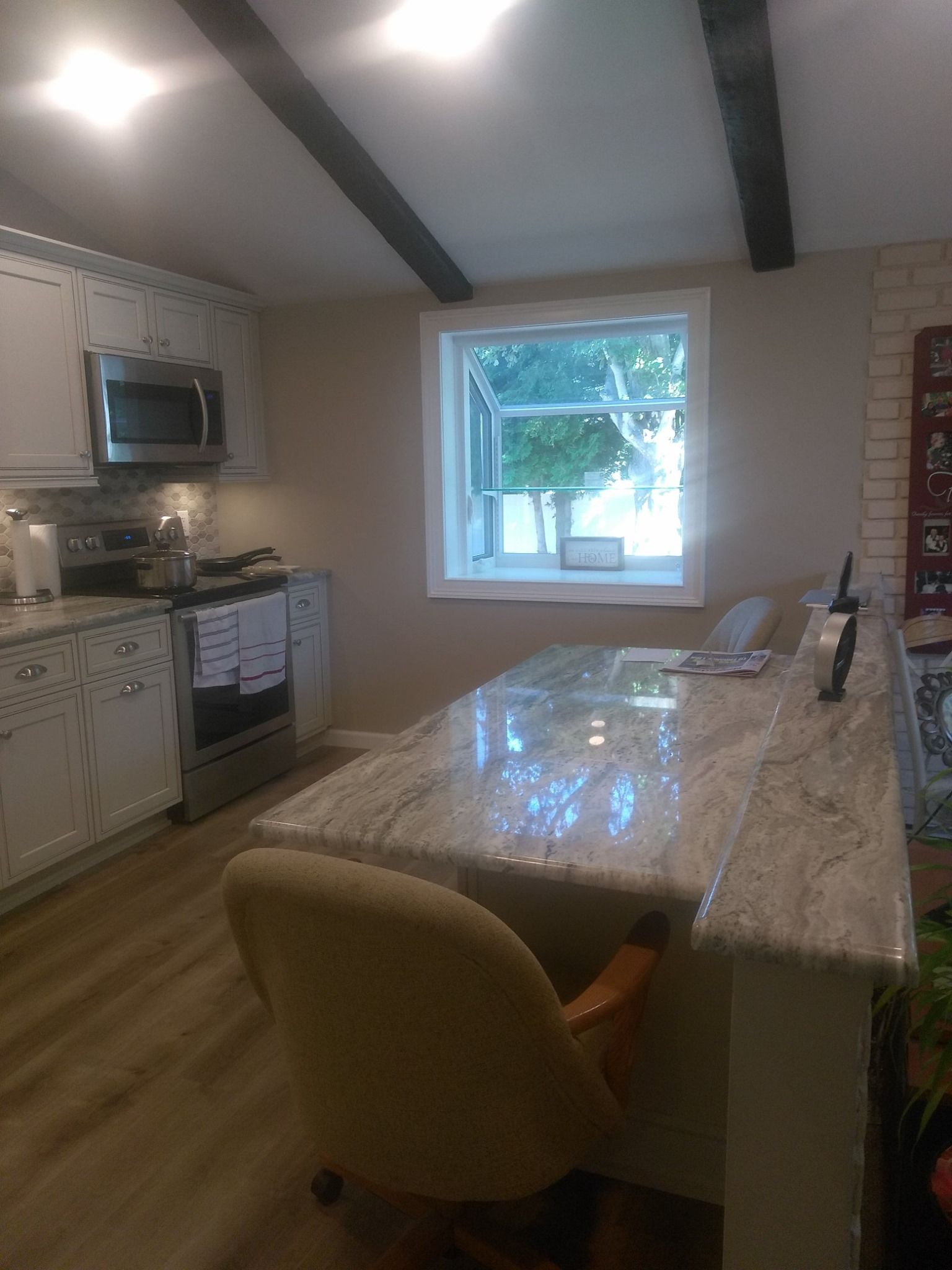 A kitchen with a table and chairs and a window.