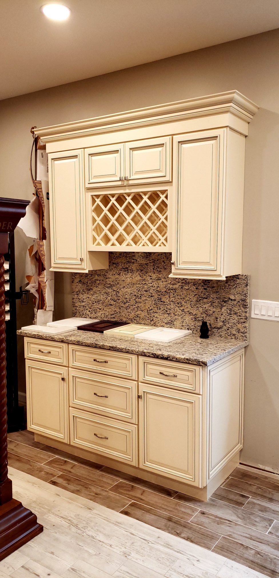 A kitchen with white cabinets and granite counter tops.