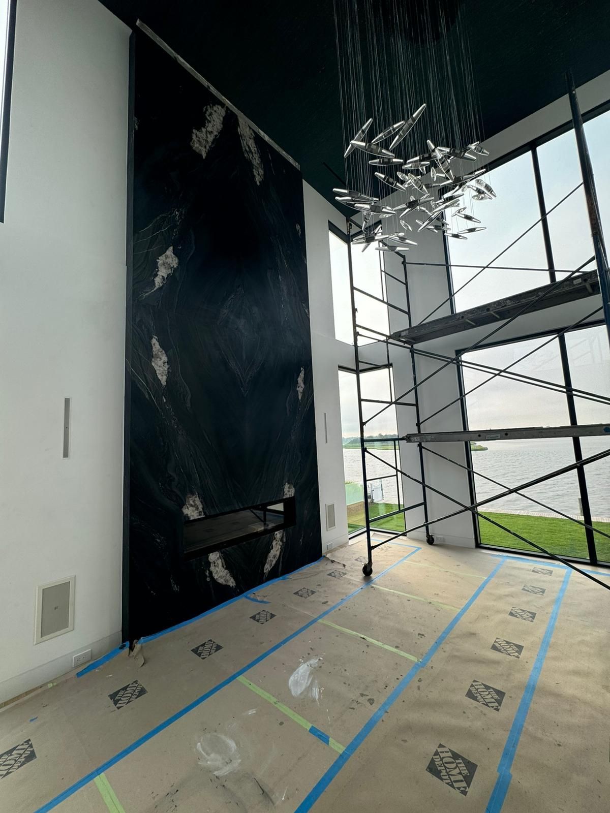 A room with a large wall and scaffolding in it