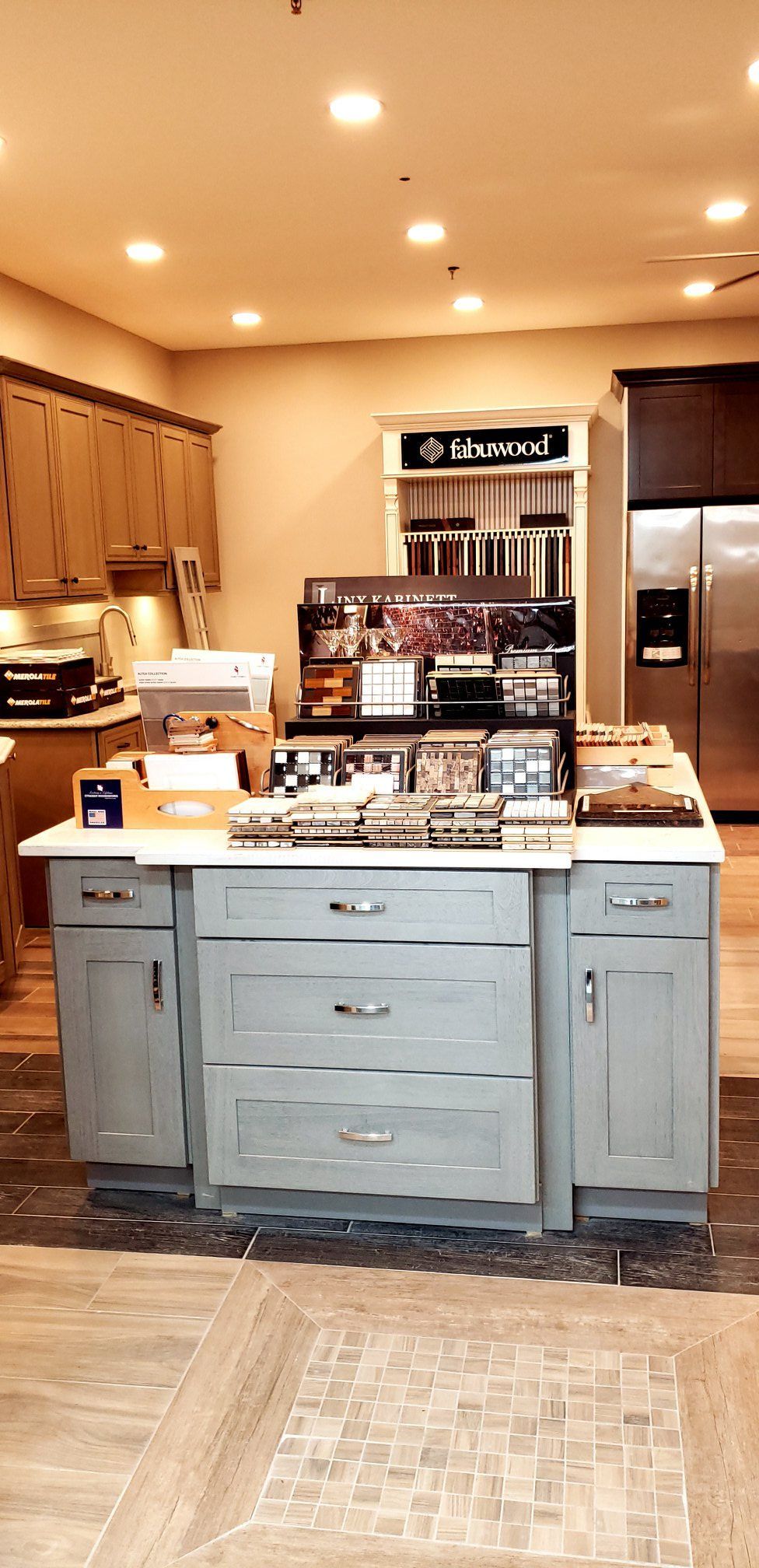 A kitchen with a large island in the middle of it.