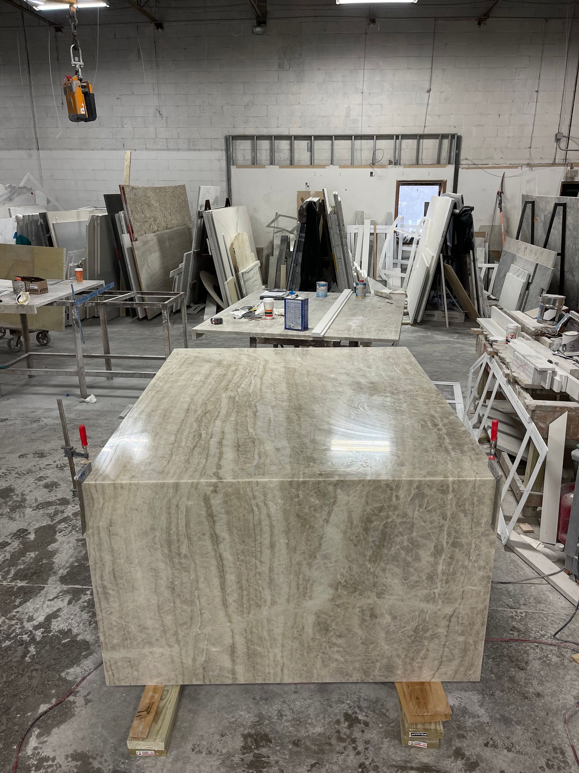 A large piece of marble is sitting on top of a wooden table in a room.
