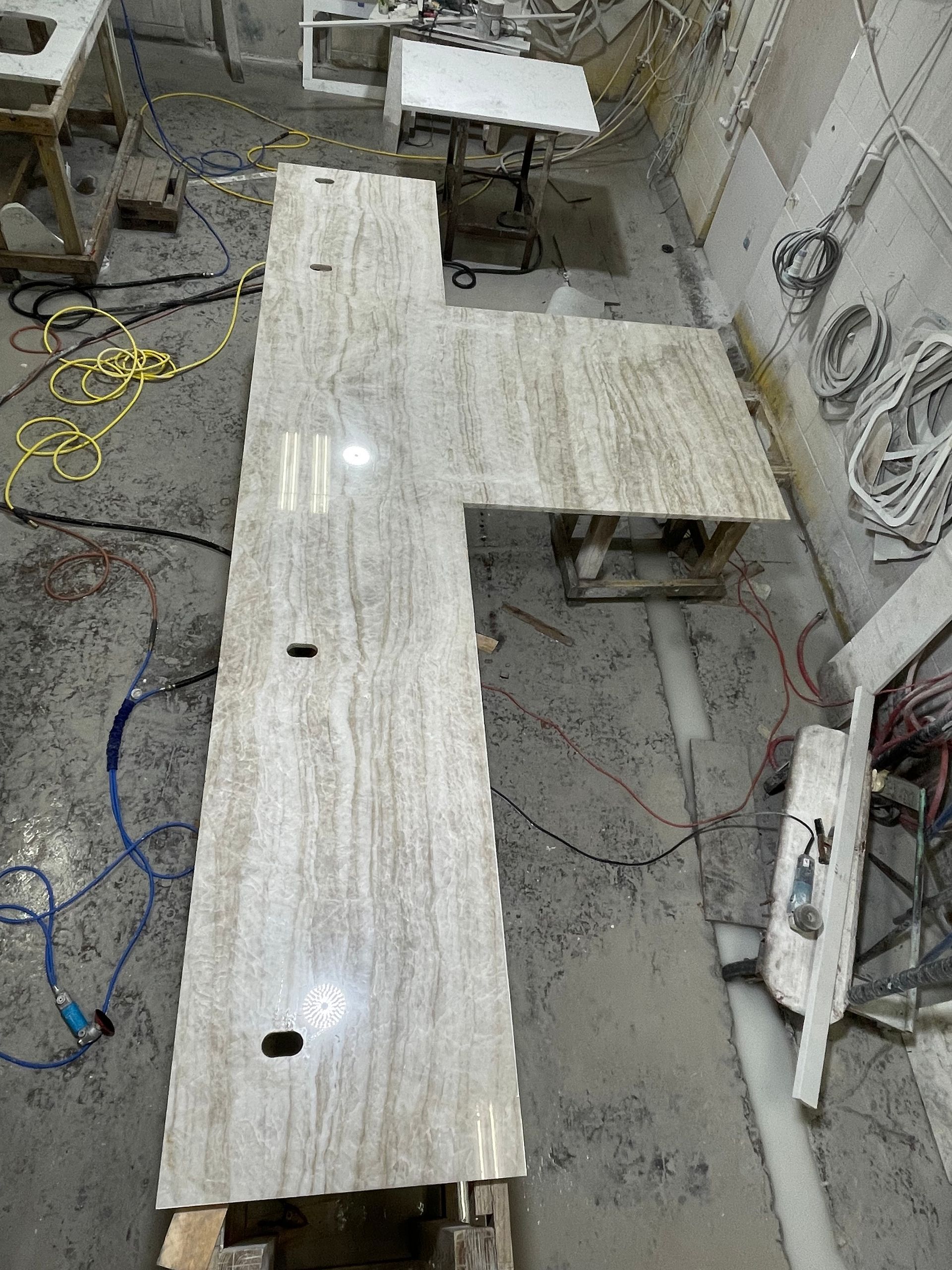 A marble counter top is being built in a workshop.