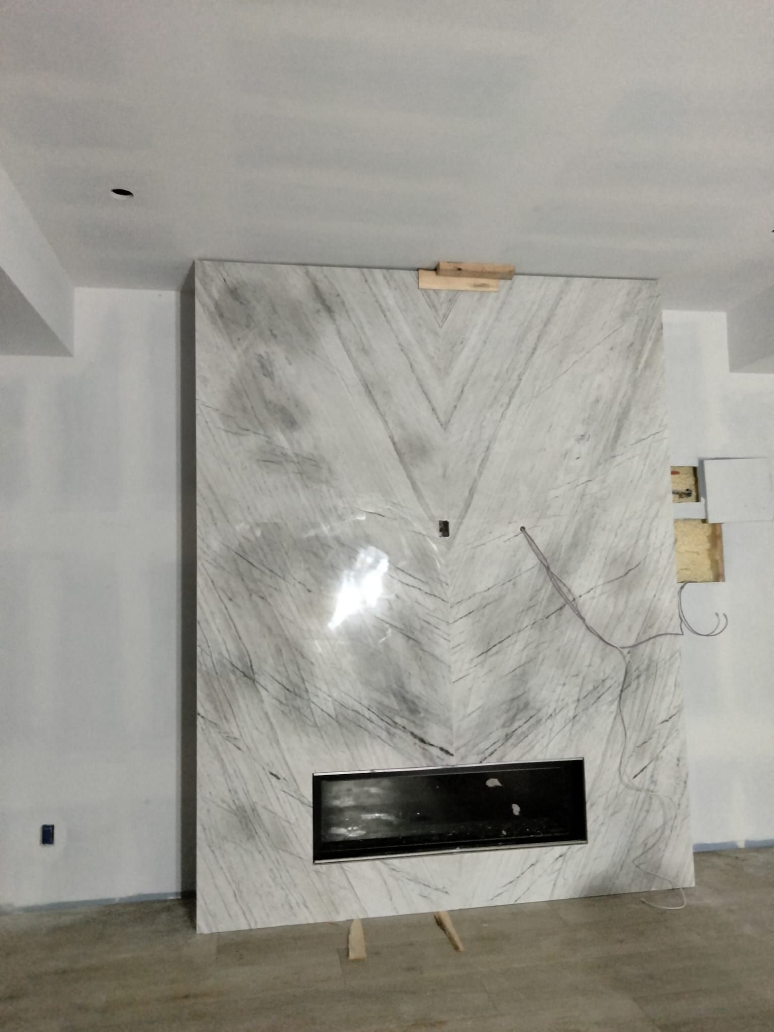 There is a fireplace in the middle of the room.