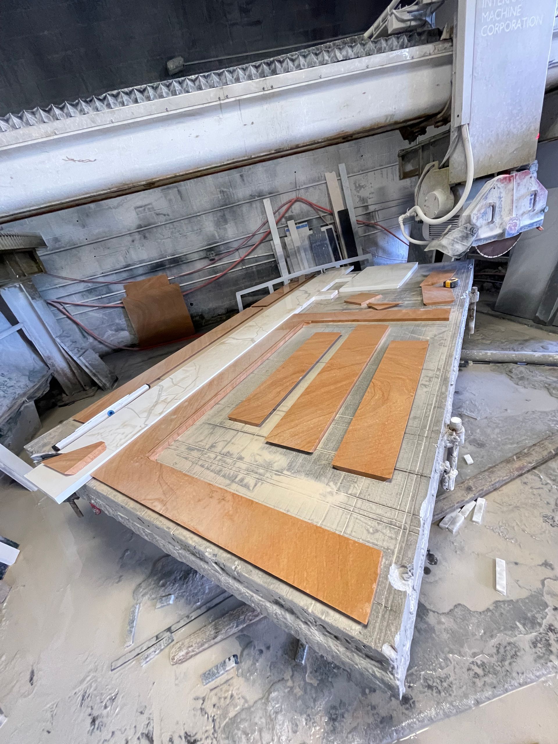 A machine is cutting a piece of wood on a table.