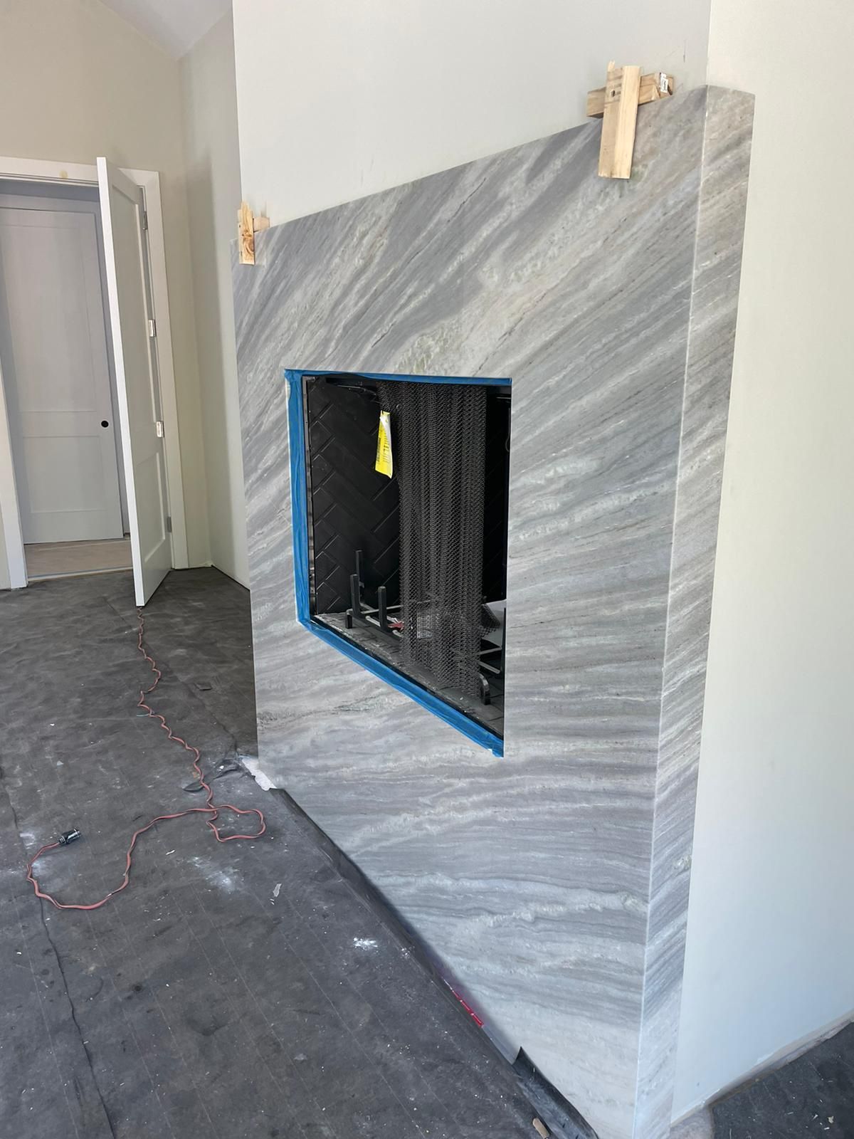 A fireplace is being built in a room in a house.