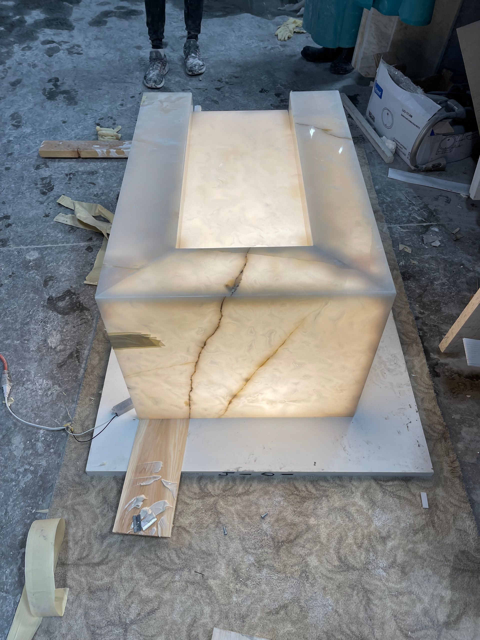 A large block of marble is sitting on top of a wooden table.