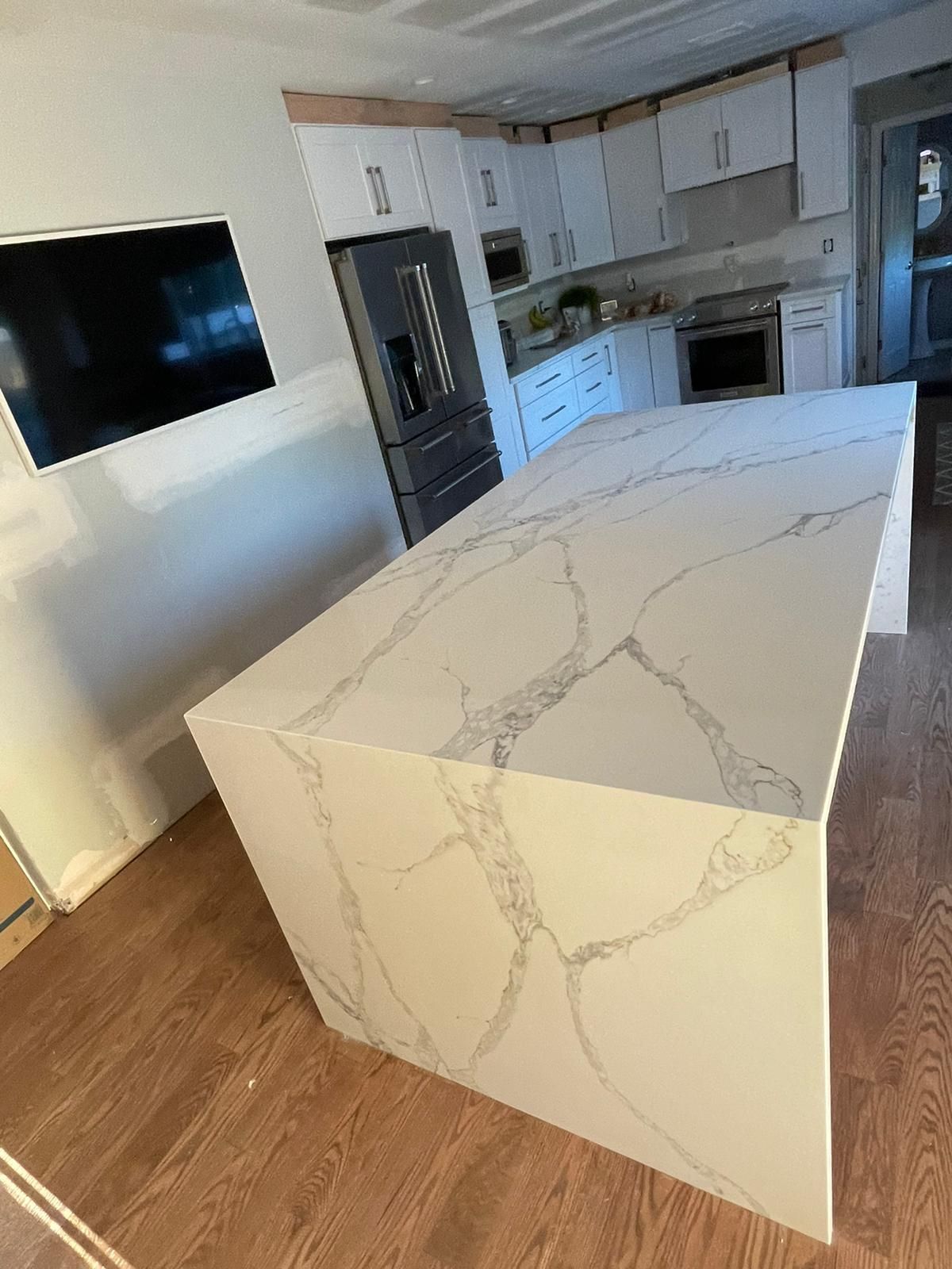 There is a large island in the middle of the kitchen.