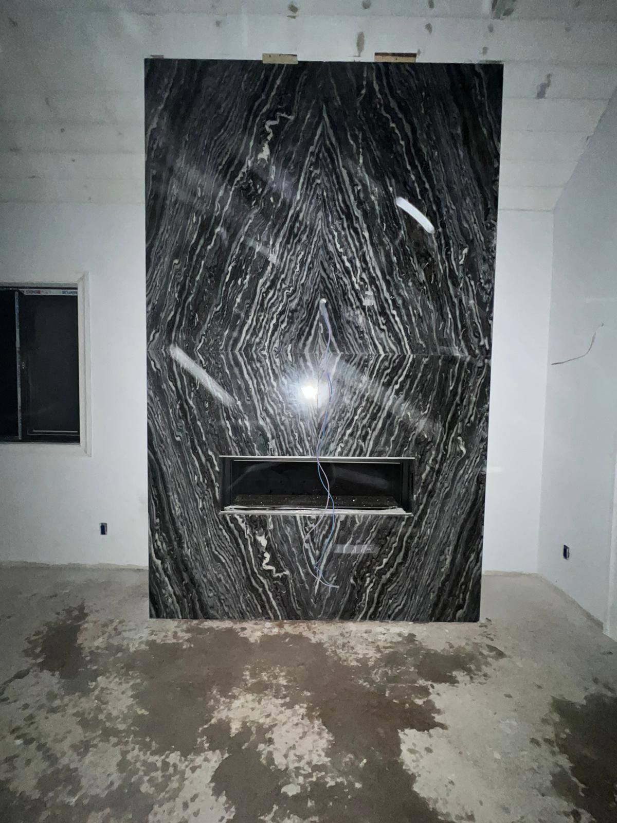 There is a fireplace in the middle of the room.