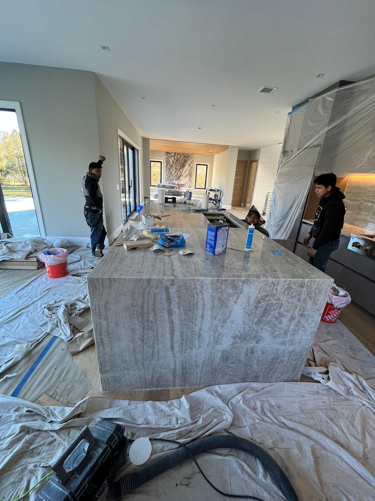 A vacuum cleaner is sitting on the floor in a kitchen under construction.