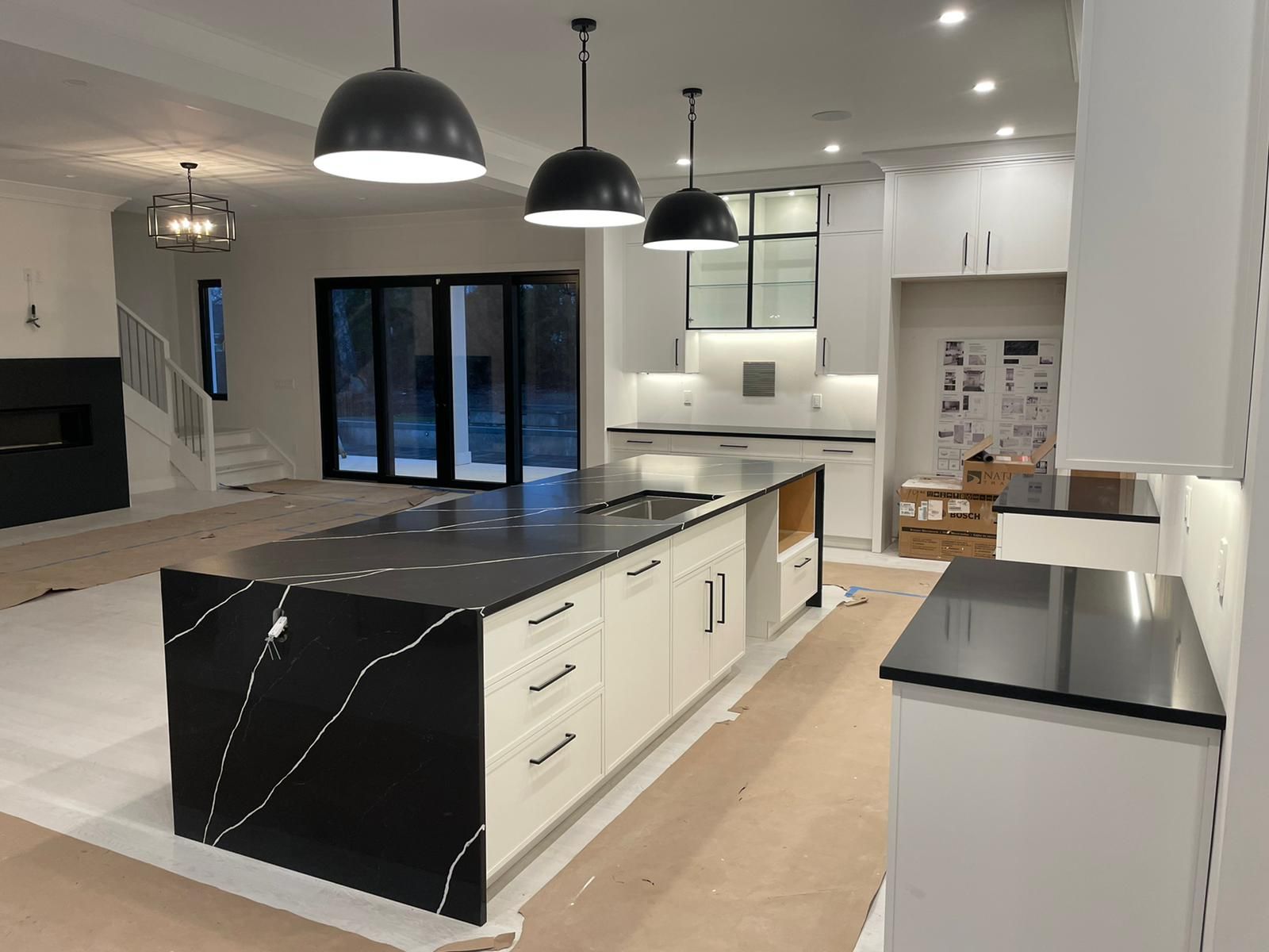 A kitchen with a large island in the middle of it.