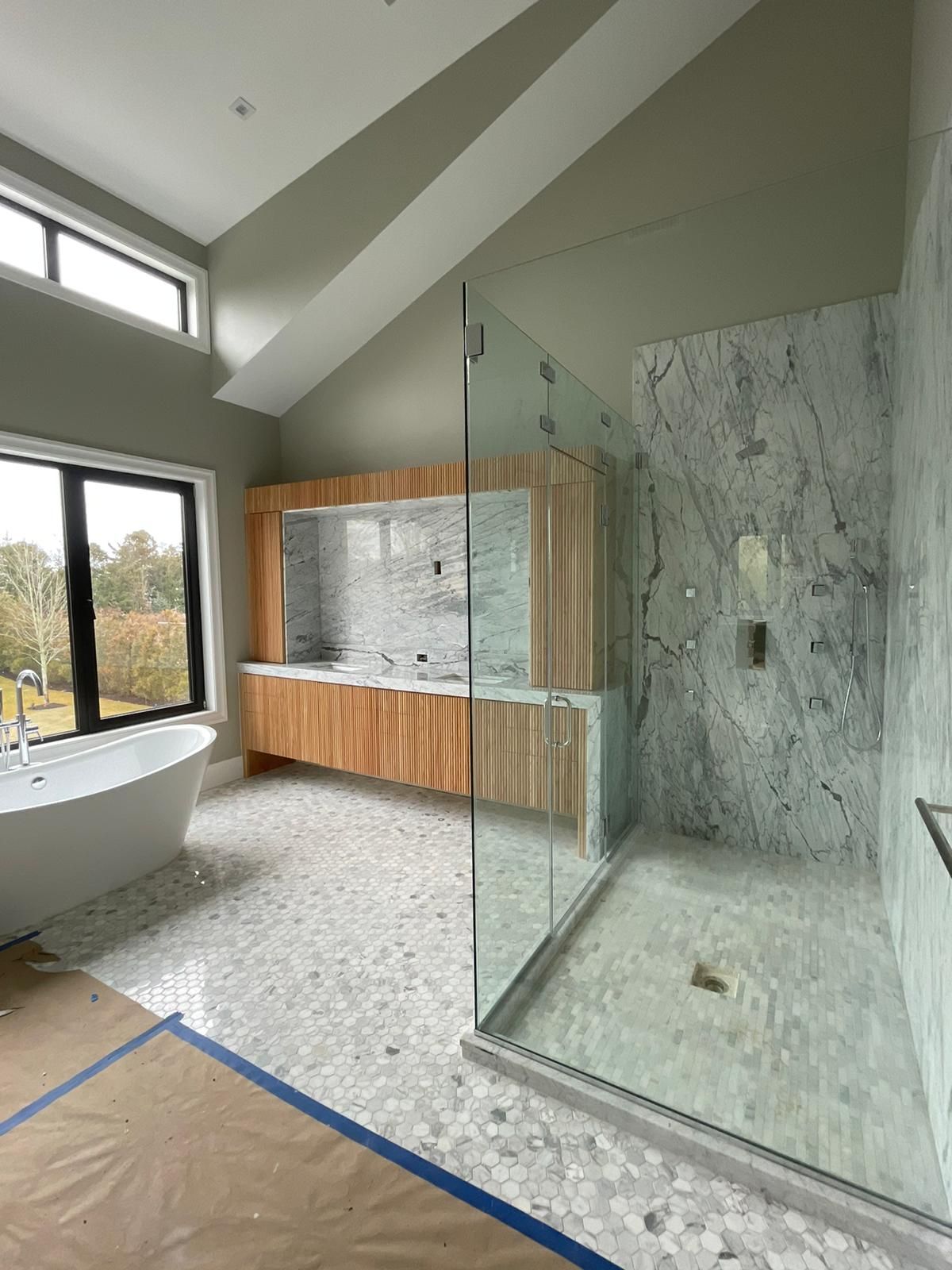 A bathroom with a bathtub and a walk-in shower.