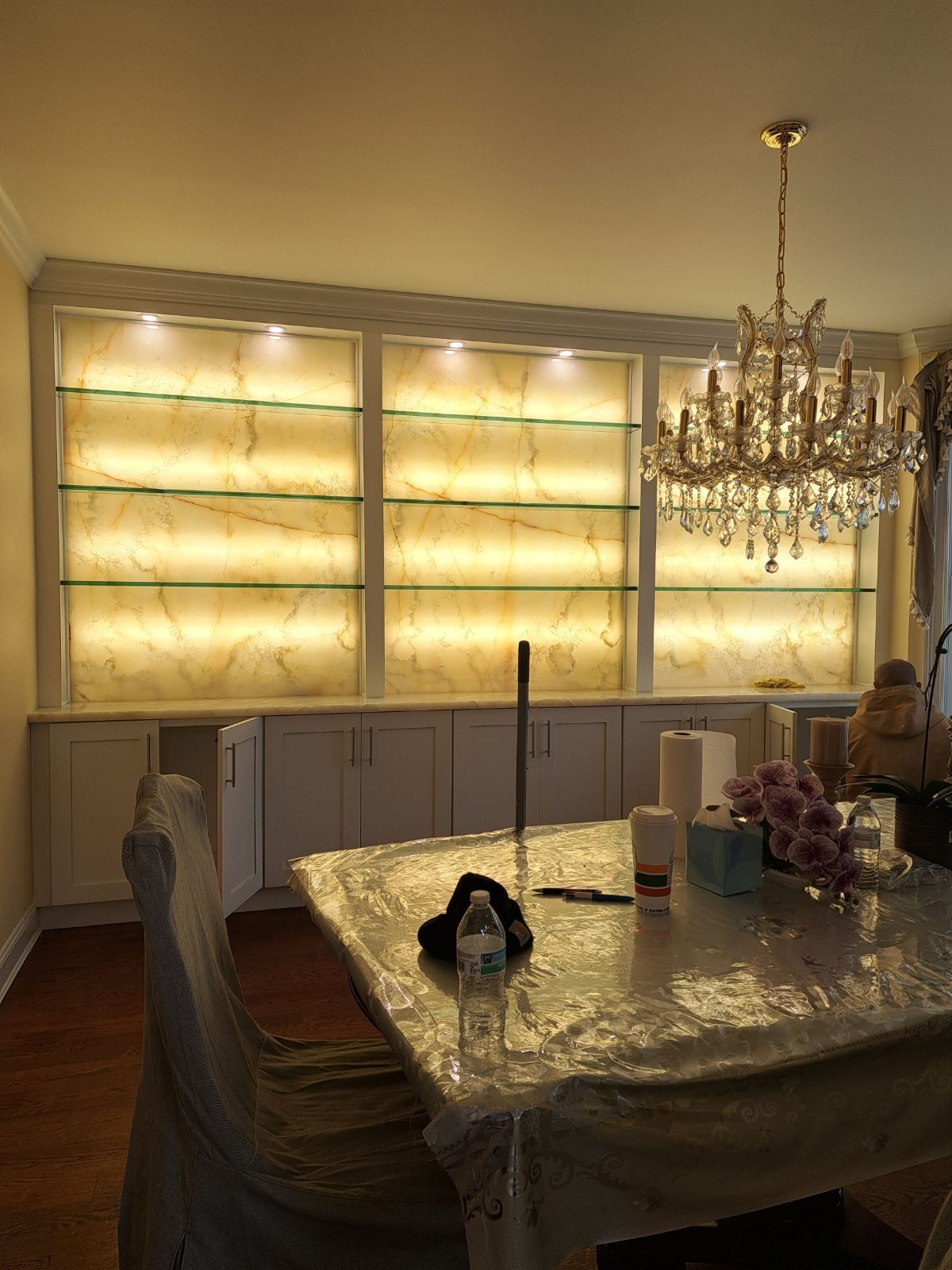 A dining room with a table and chairs and a chandelier.