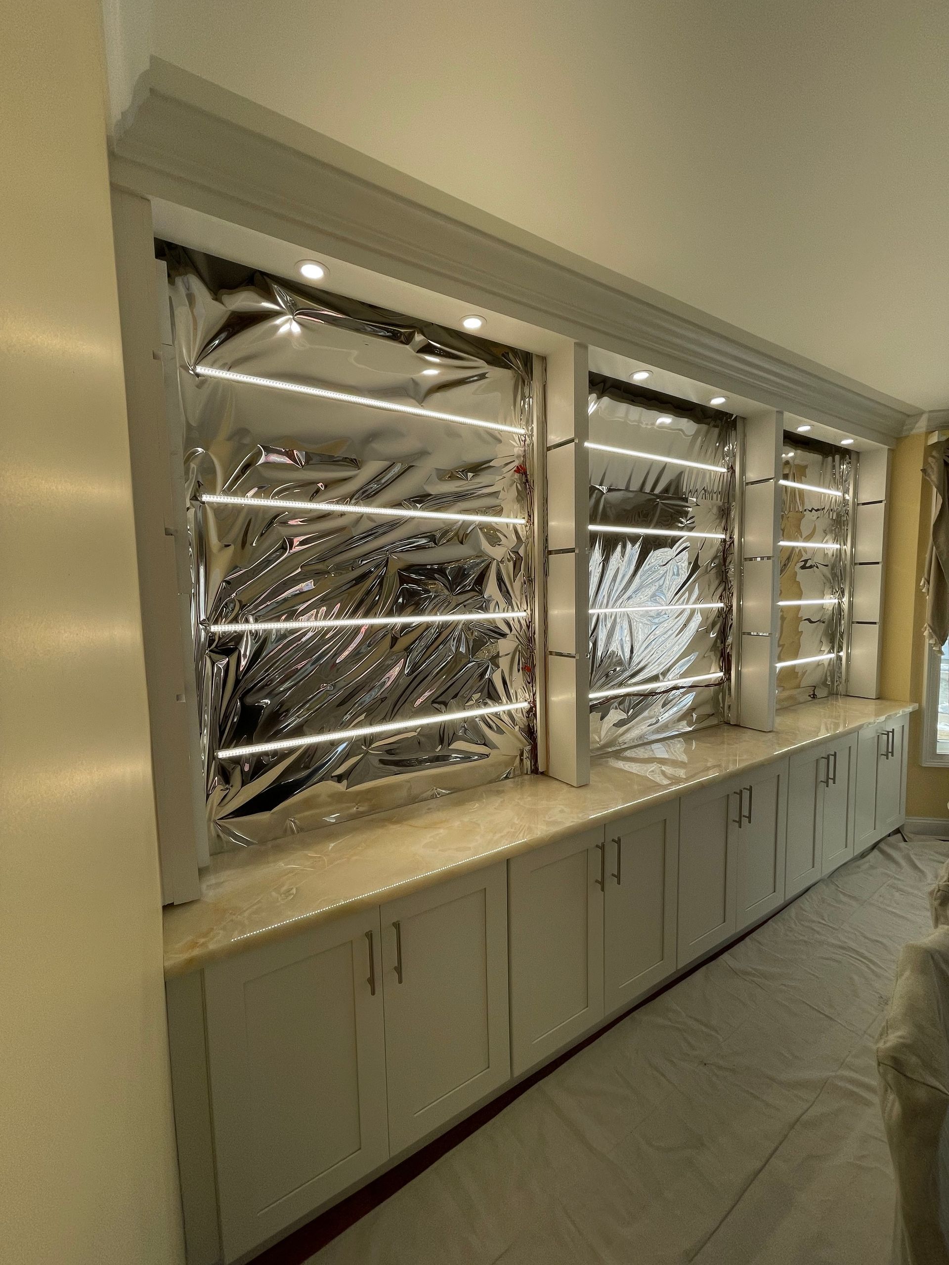 A room with a lot of cabinets and shelves and a window.