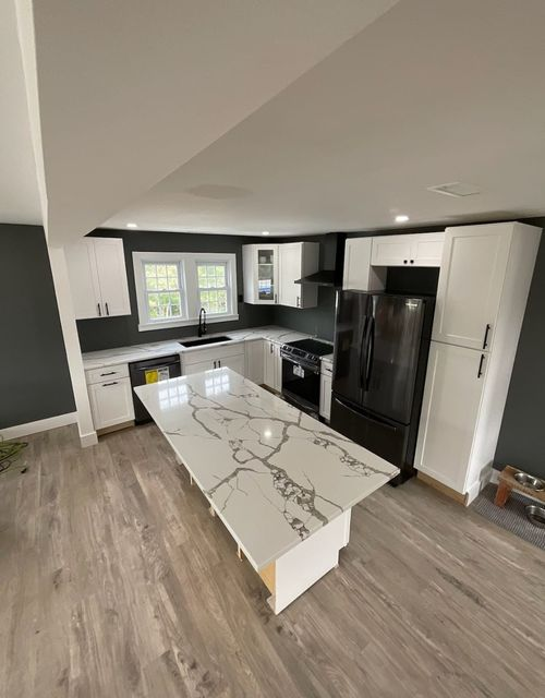 There is a large island in the middle of the kitchen.