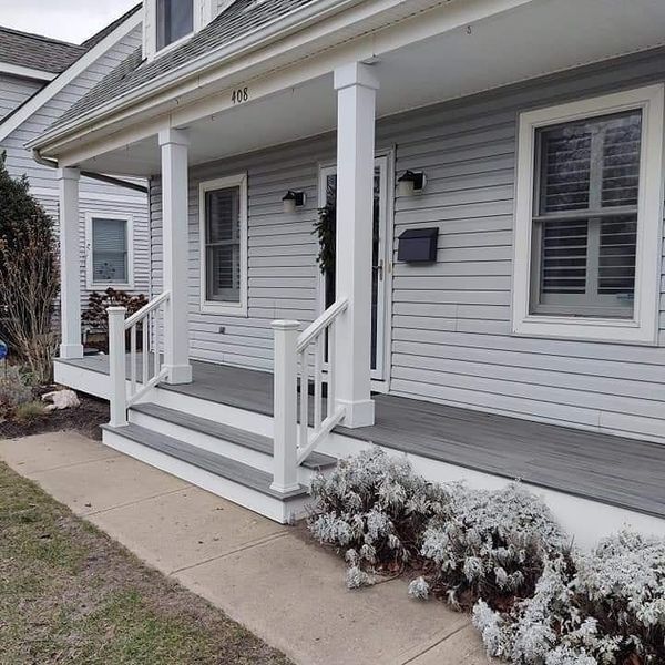 The front of a house with a porch and stairs