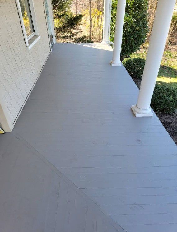 Gray painted porch with white columns.